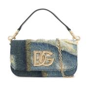 Patchwork denim skuldertaske med gul logo